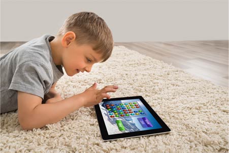 Young child playing with tablet device